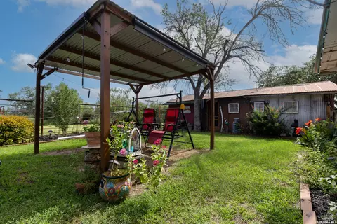 Exterior - 235 County Road 7712, Devine, TX 78016 photo 4 of 12