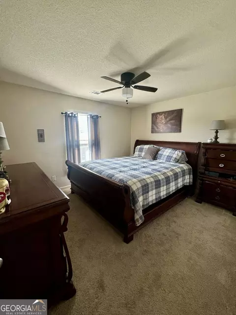Bedroom - 10783 Wheeler Trce, Hampton, GA 30228 photo 4 of 6