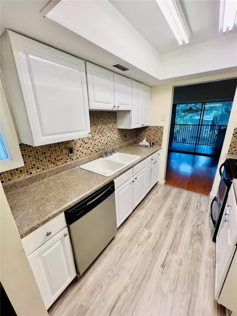 Kitchen - 6057 Windhover Dr #E-08, Orlando, FL 32819 photo 2 of 2