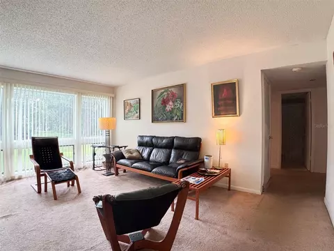 Living - 5885 Windhover Dr #4E, Orlando, FL 32819 photo 3 of 3