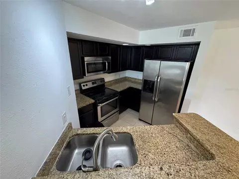 Kitchen - 4532 Commander Dr #2128, Orlando, FL 32822 photo 3 of 3