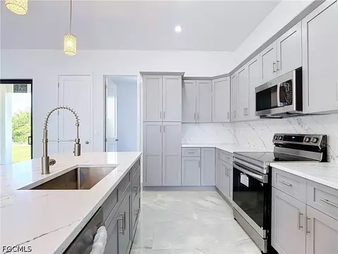 Kitchen - 105 Ruby Ave N, Lehigh Acres, FL 33971 photo 3 of 7