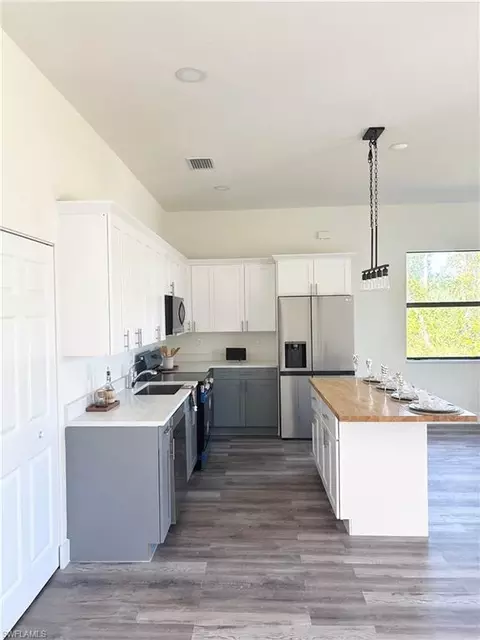 Kitchen - 411 Eisenhower Blvd, Lehigh Acres, FL 33974 photo 3 of 3