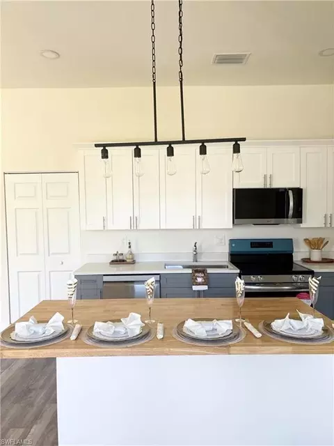 Kitchen - 411 Eisenhower Blvd, Lehigh Acres, FL 33974 photo 1 of 3
