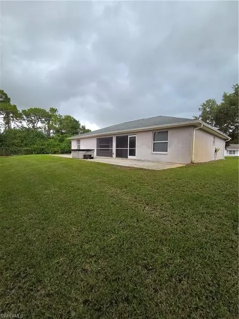 Exterior - 1025 Iris St E, Lehigh Acres, FL 33974 photo 7 of 13