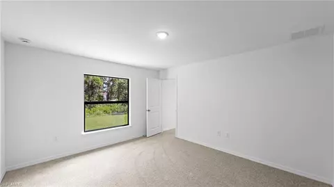 Bedroom - 643 Chambers St E, Lehigh Acres, FL 33974 photo 3 of 7