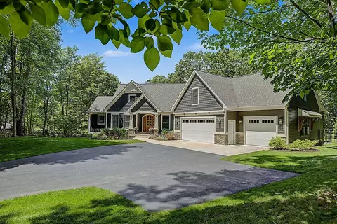 Exterior - 547 Roundtree Dr NE, Ada, MI 49301 photo 4 of 24