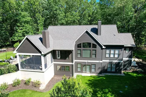 Exterior - 547 Roundtree Dr NE, Ada, MI 49301 photo 7 of 24